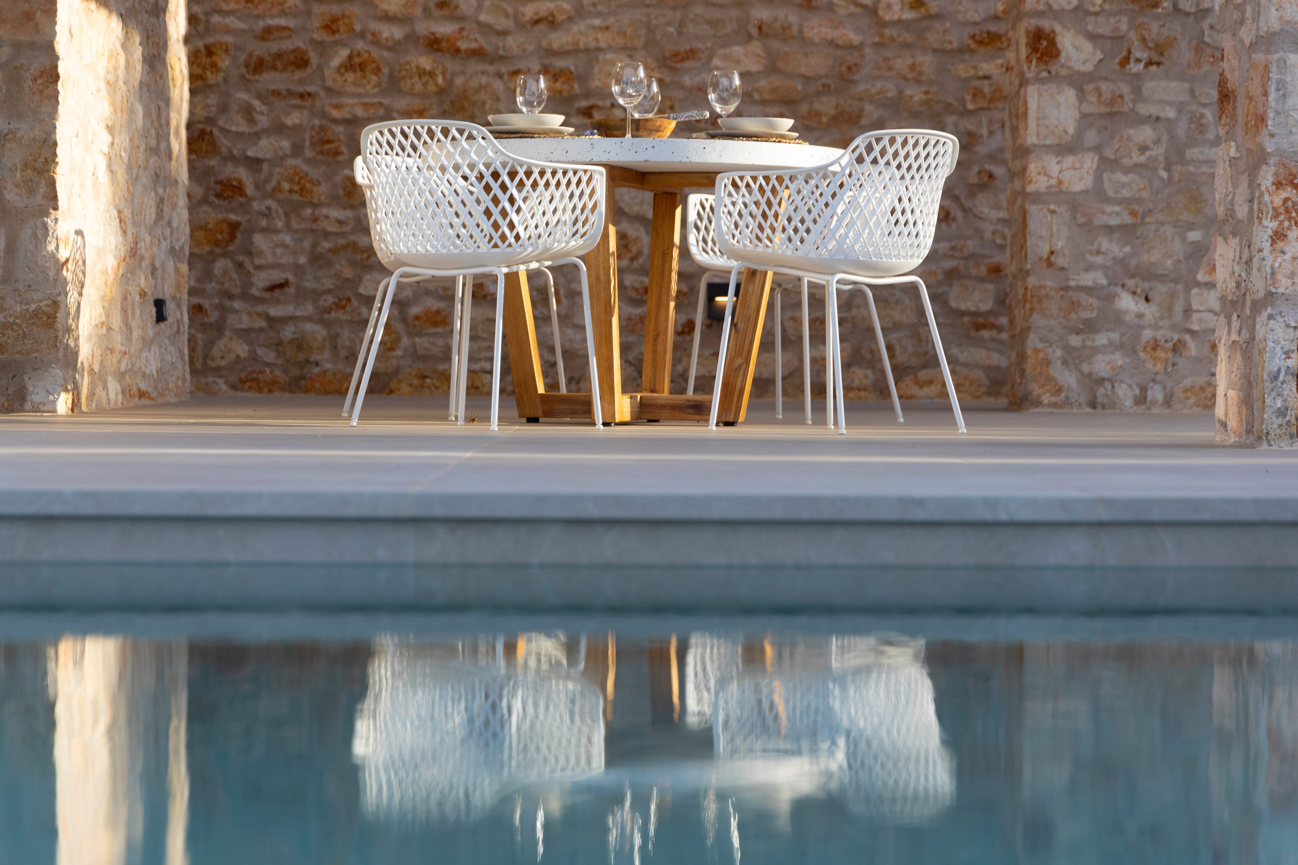 a table and chairs by a pool