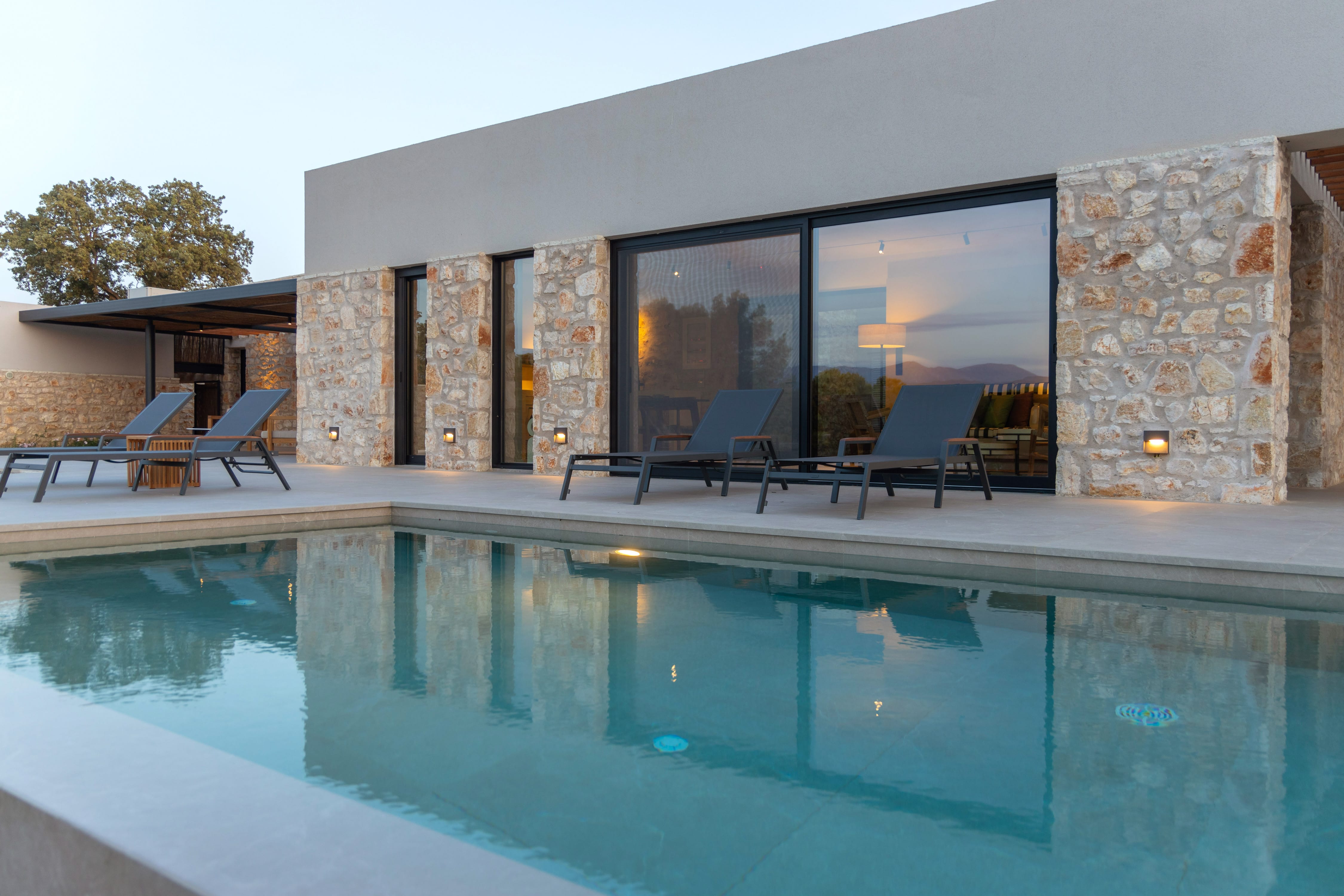 a swimming pool with a stone building in the background