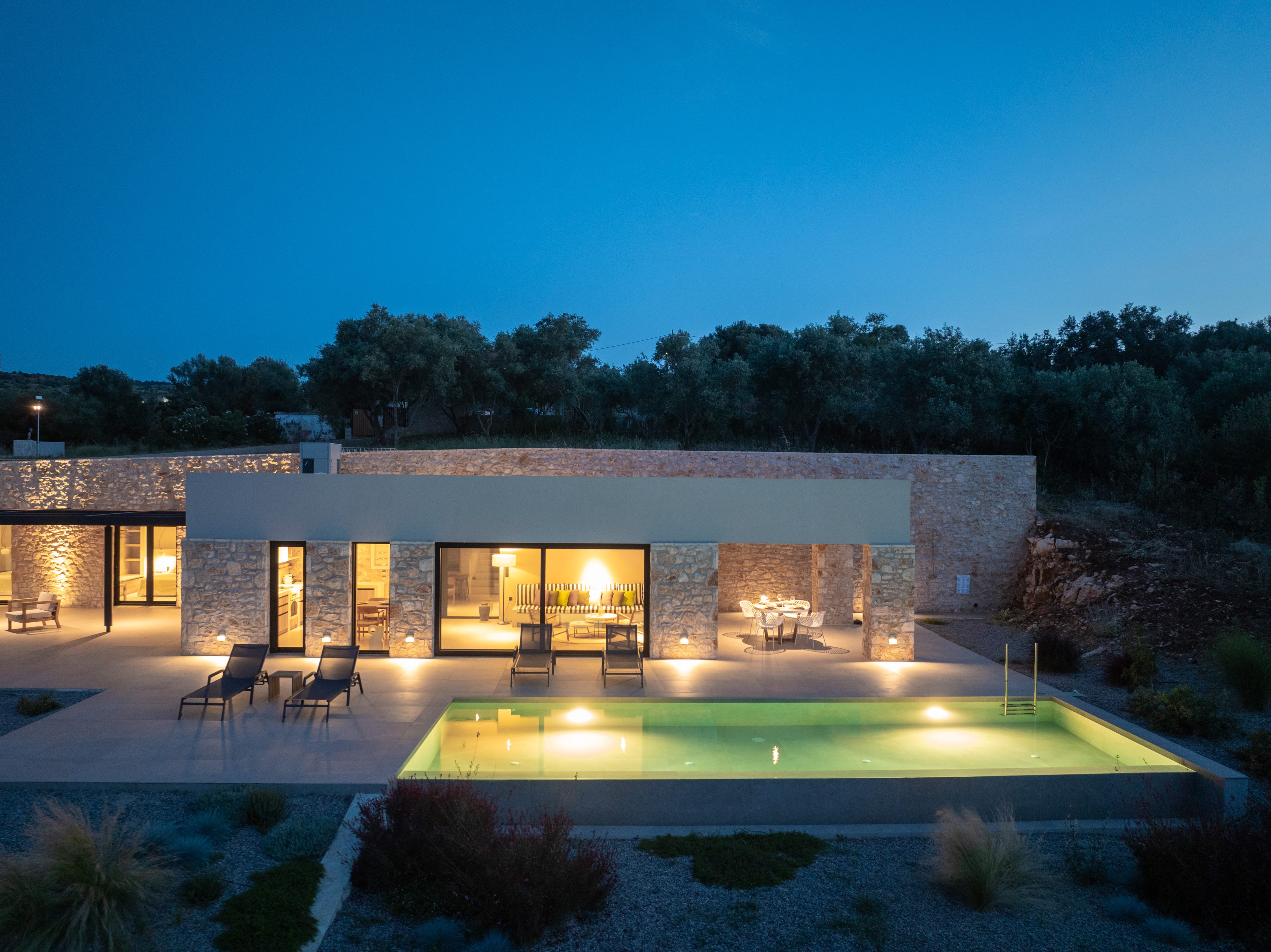 a house with a pool and trees in the background