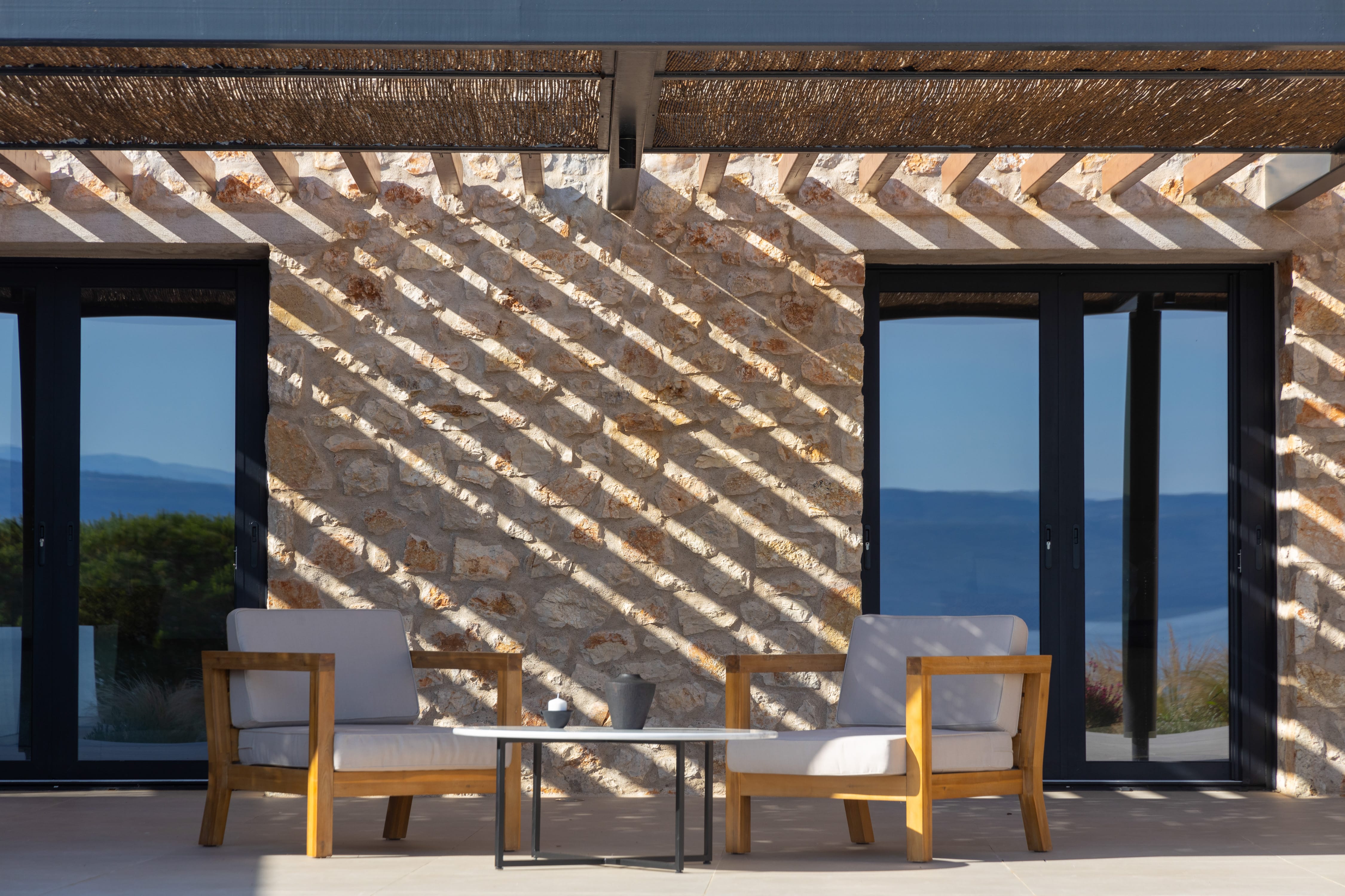 a wood house with a patio and a large window