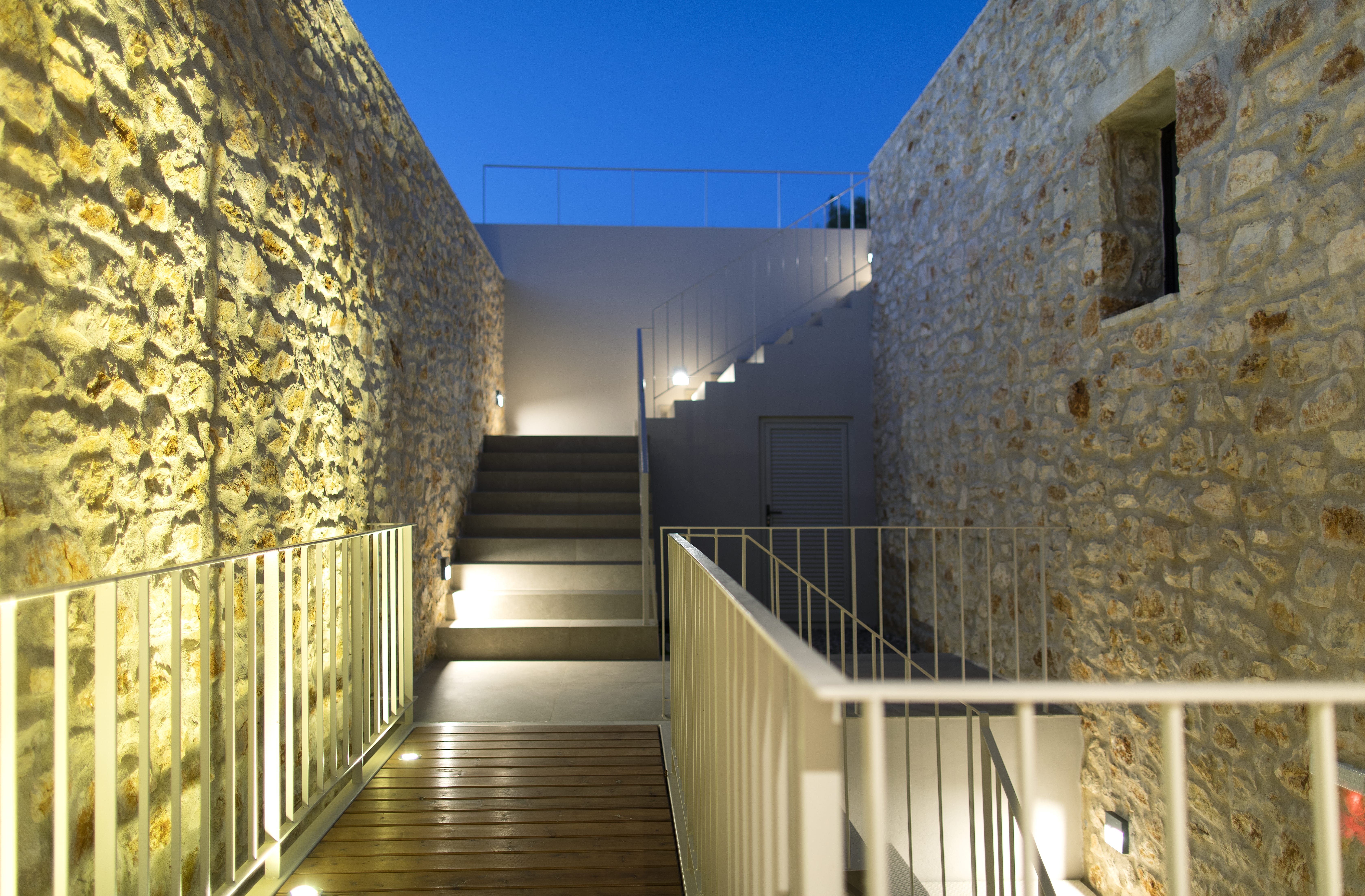 a narrow staircase between two stone walls