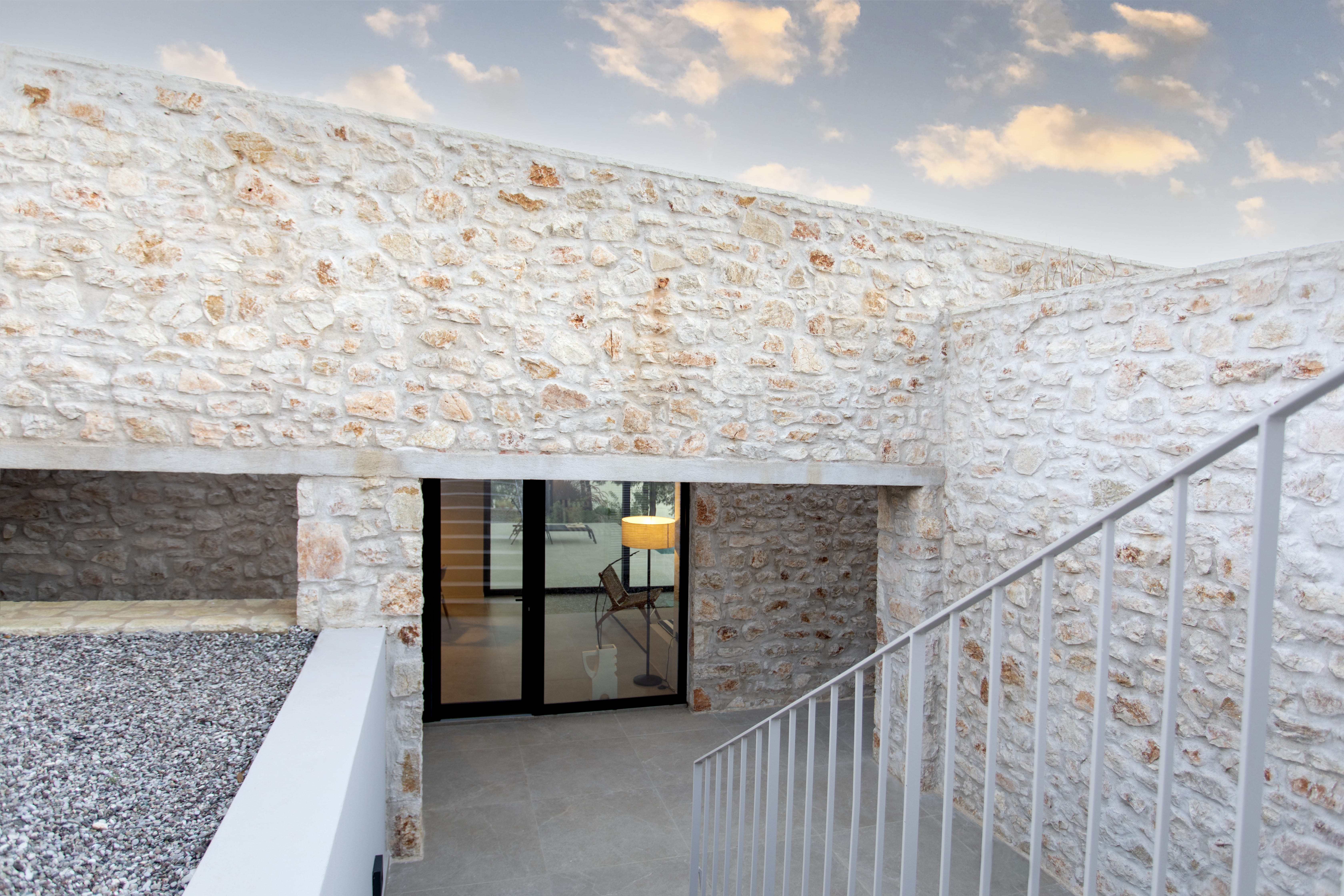 a stone building with a stone wall