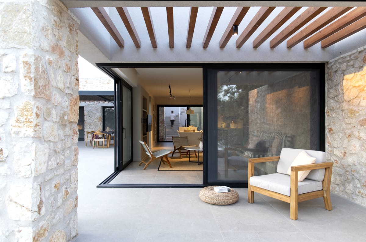 a room with a glass door and a chair and a table