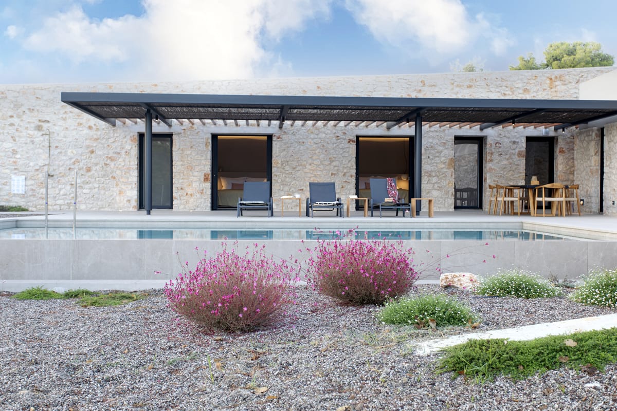a house with a pool and chairs