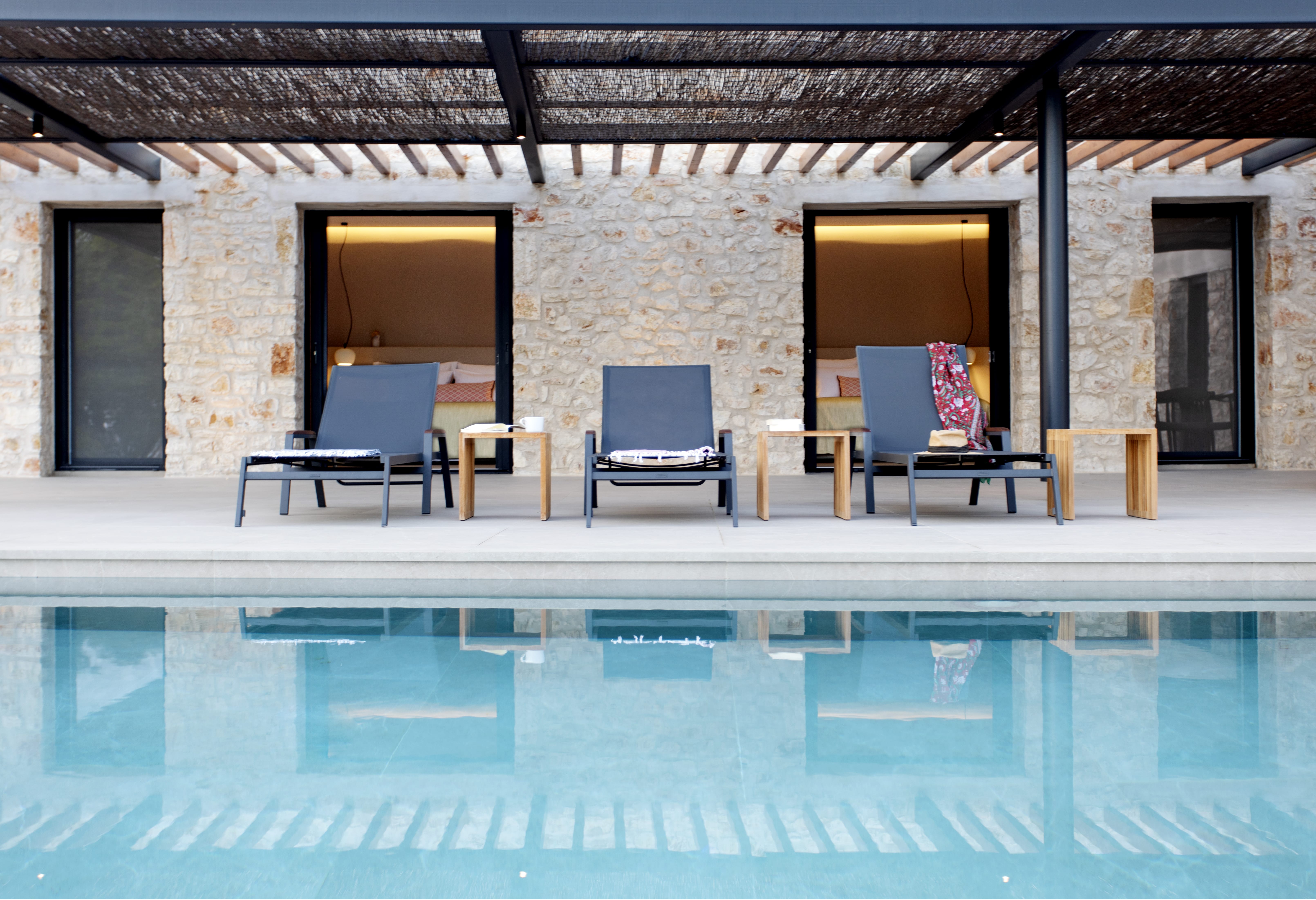 a pool with chairs and a table