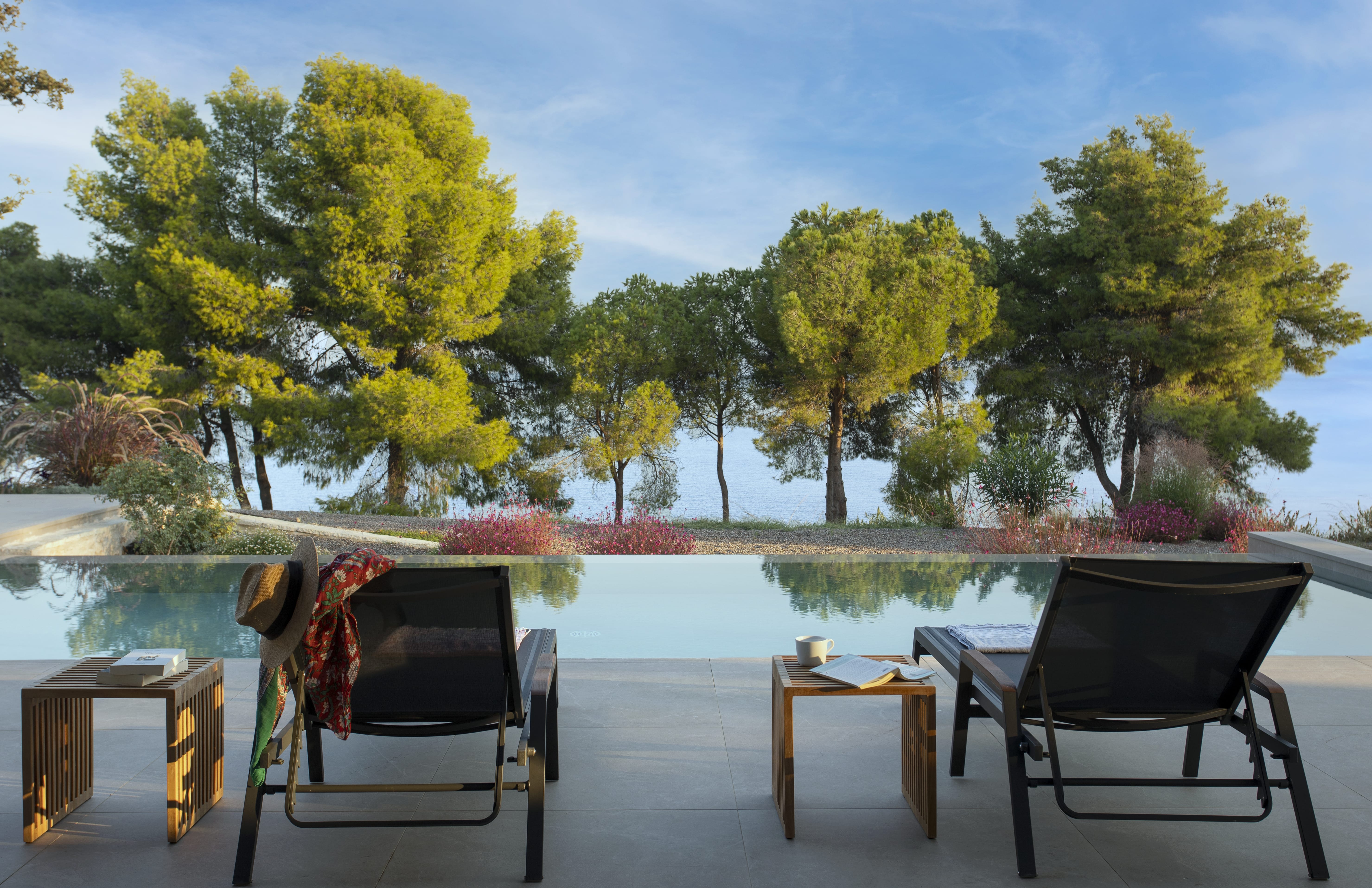 chairs and a table by a pool