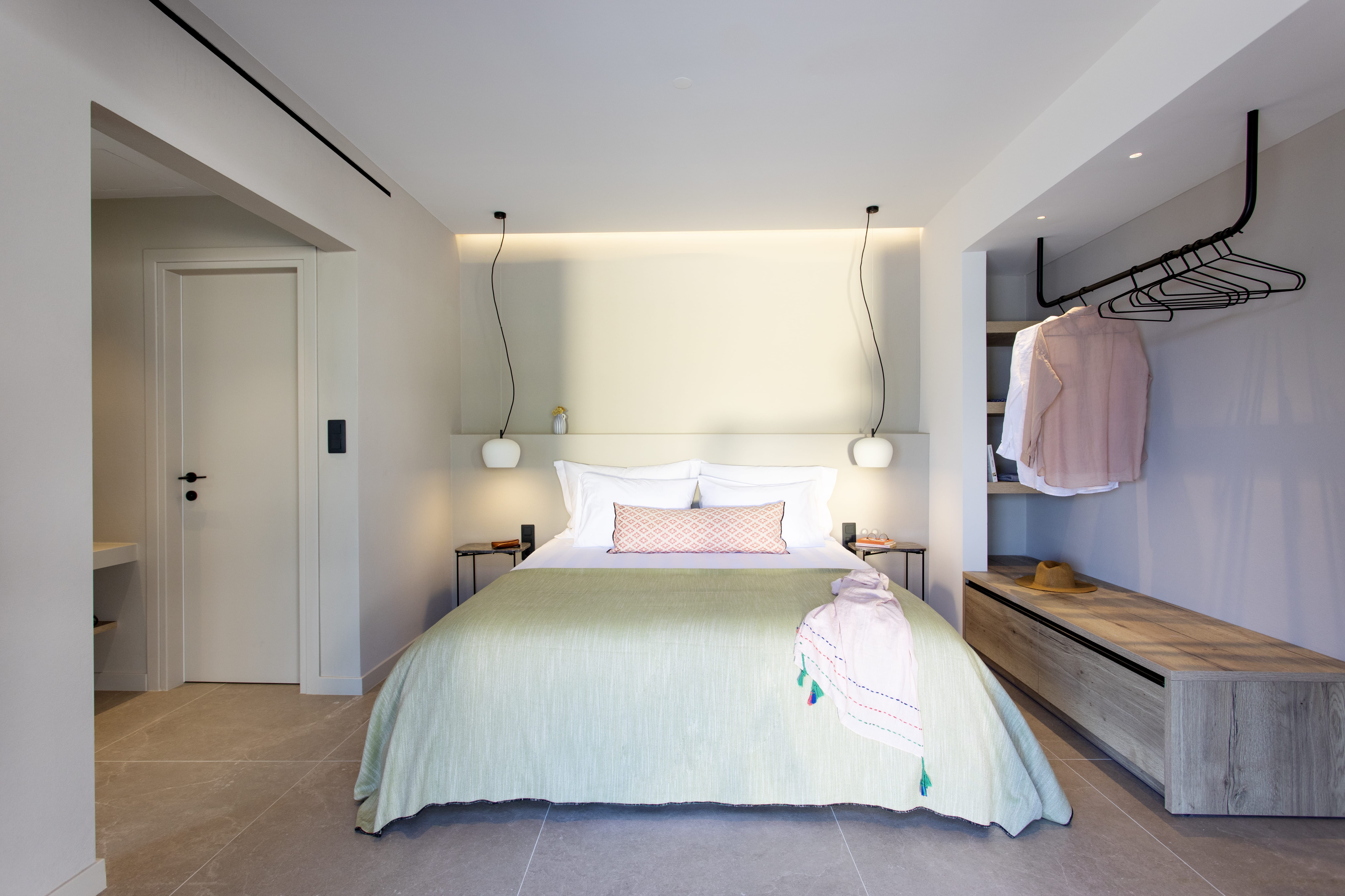 a bedroom with a bed and a bench