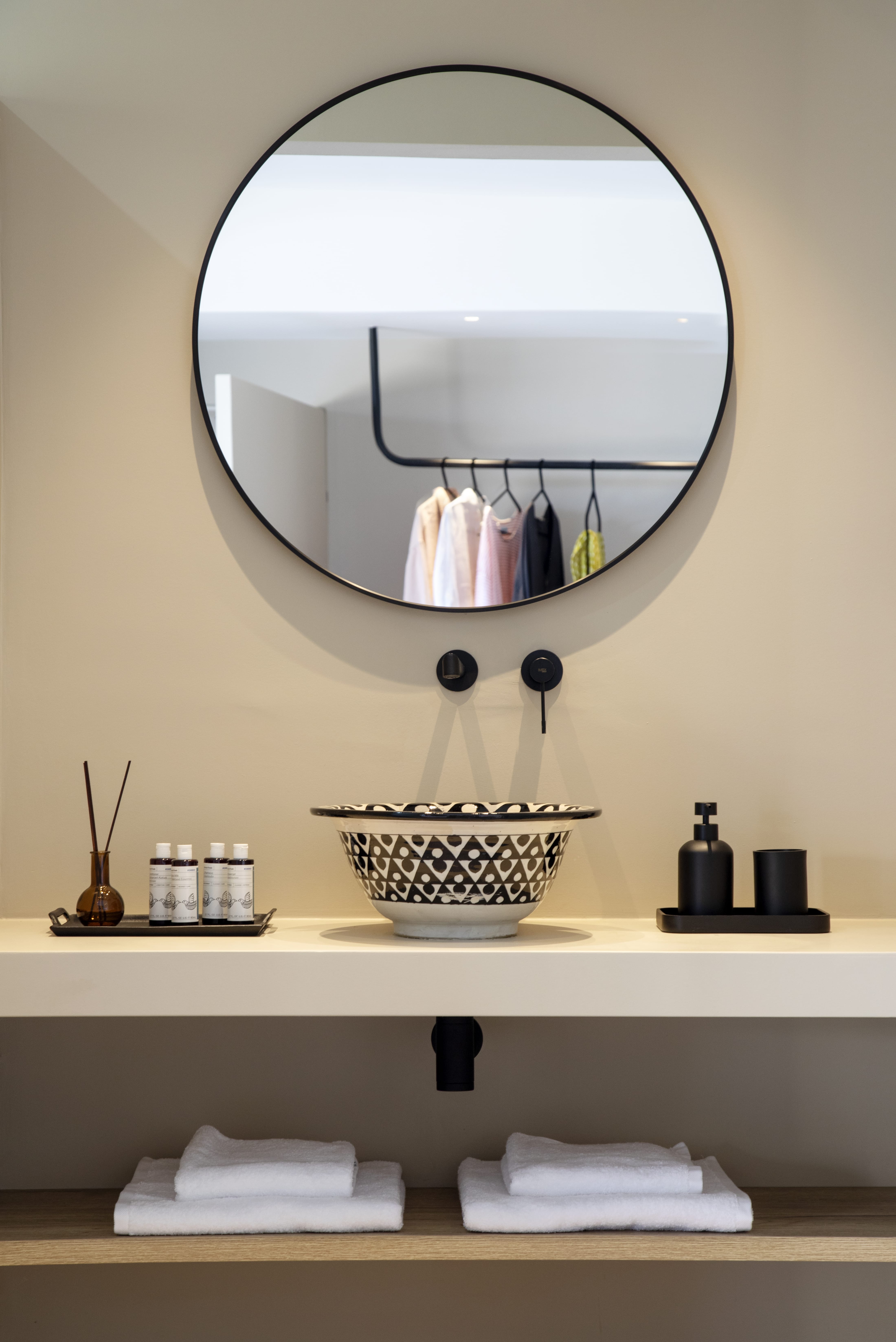 a mirror above a shelf