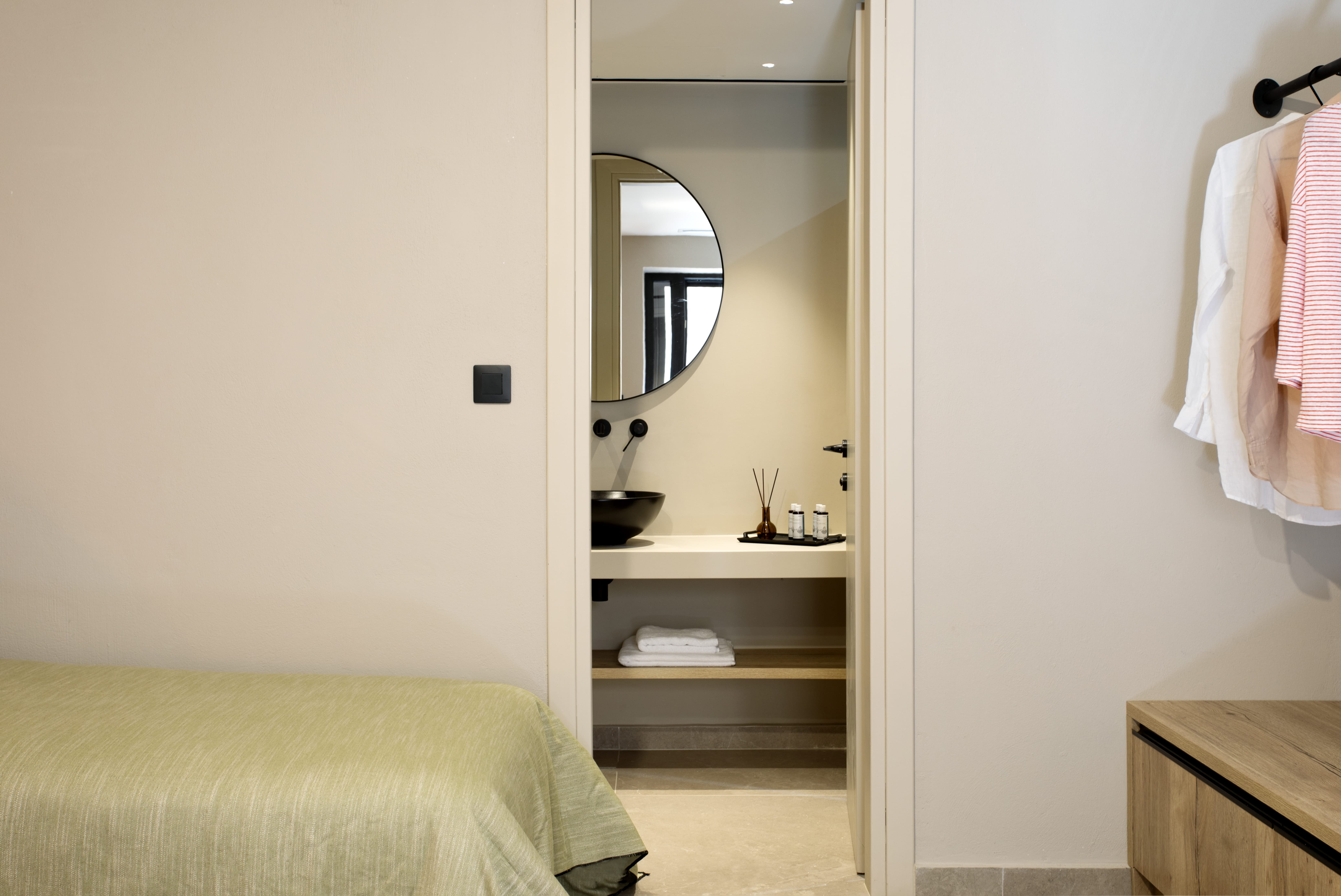 a bathroom with a mirror and a bed