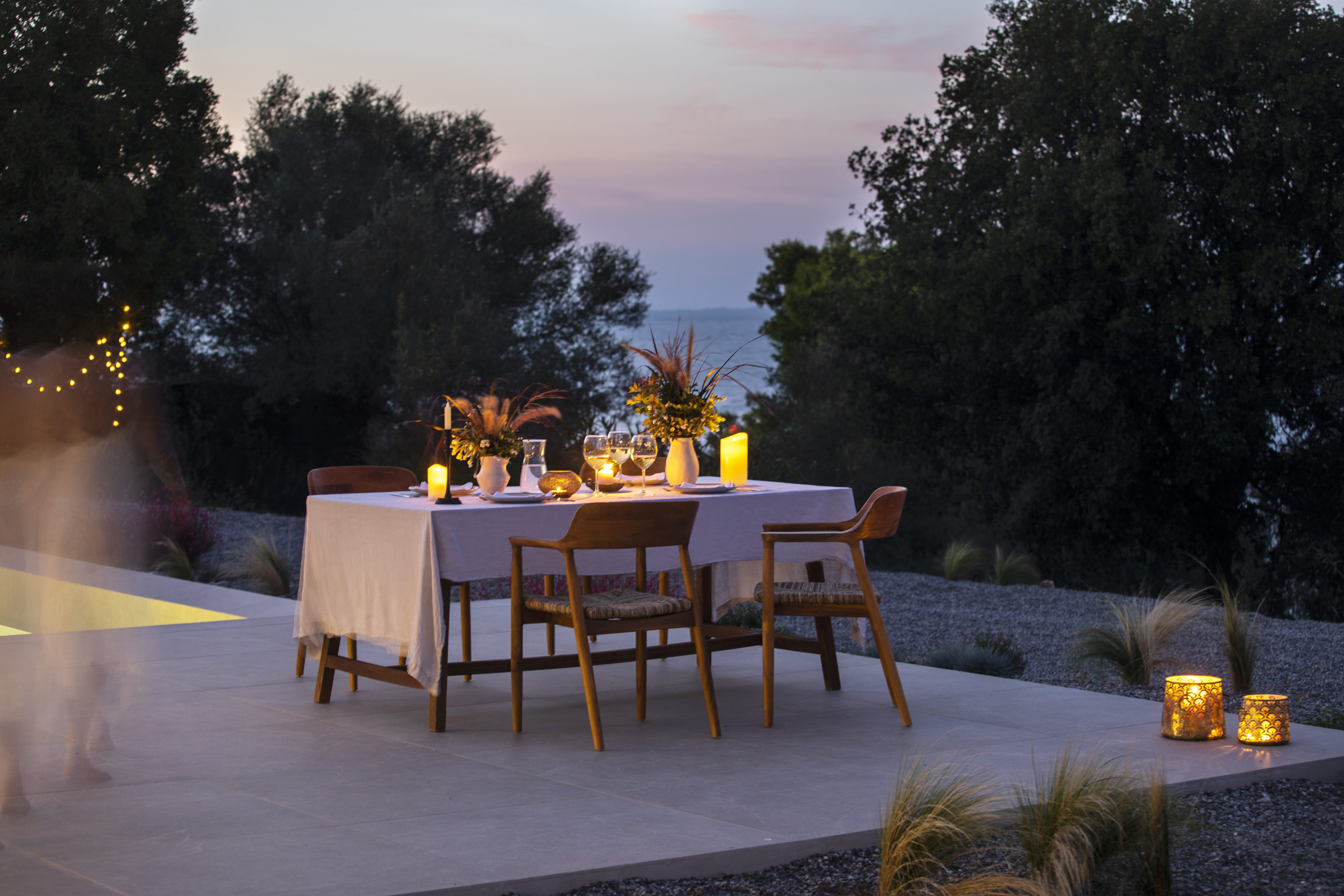 a table with chairs and a set of tables on a deck