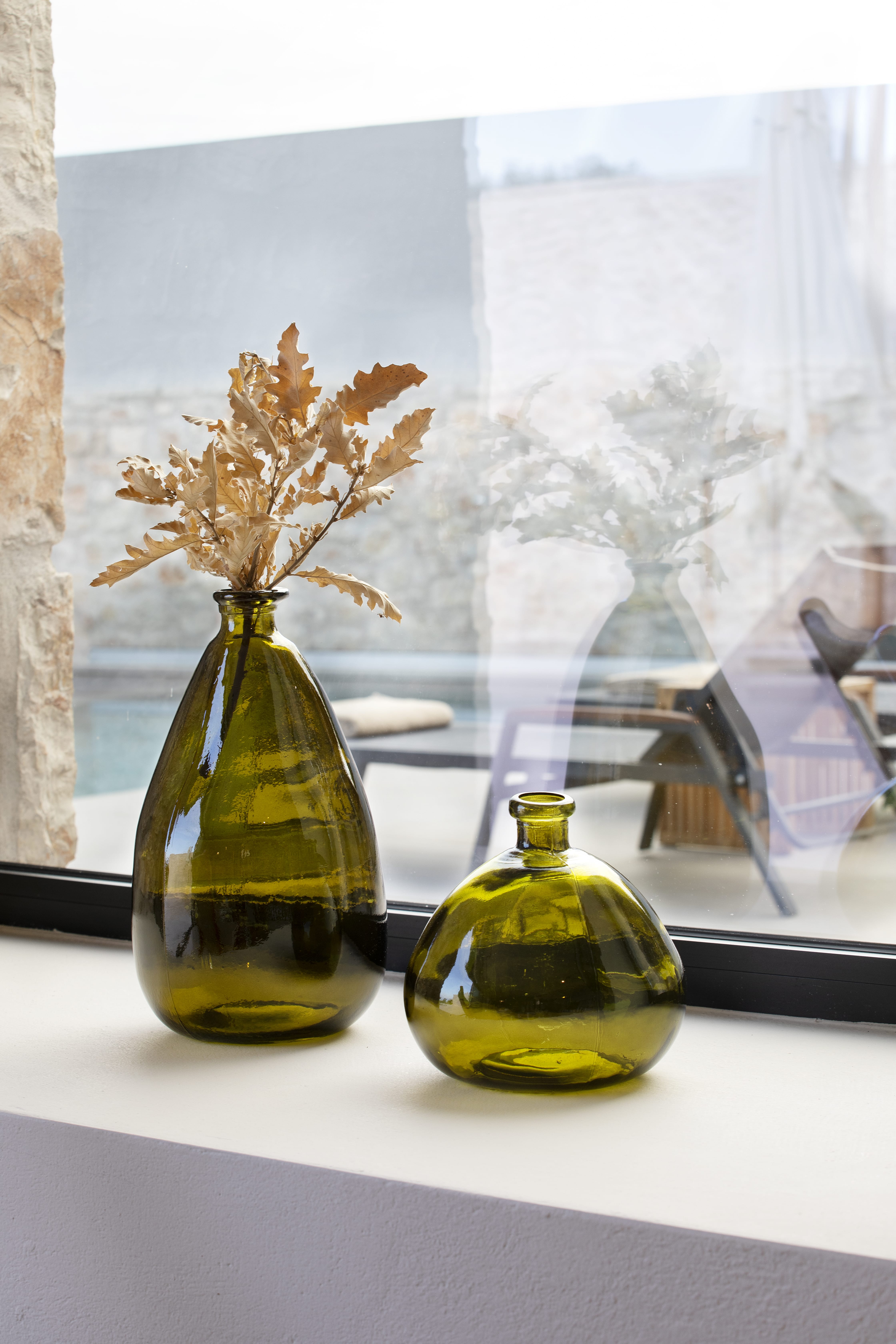 a couple of vases with yellow flowers in them