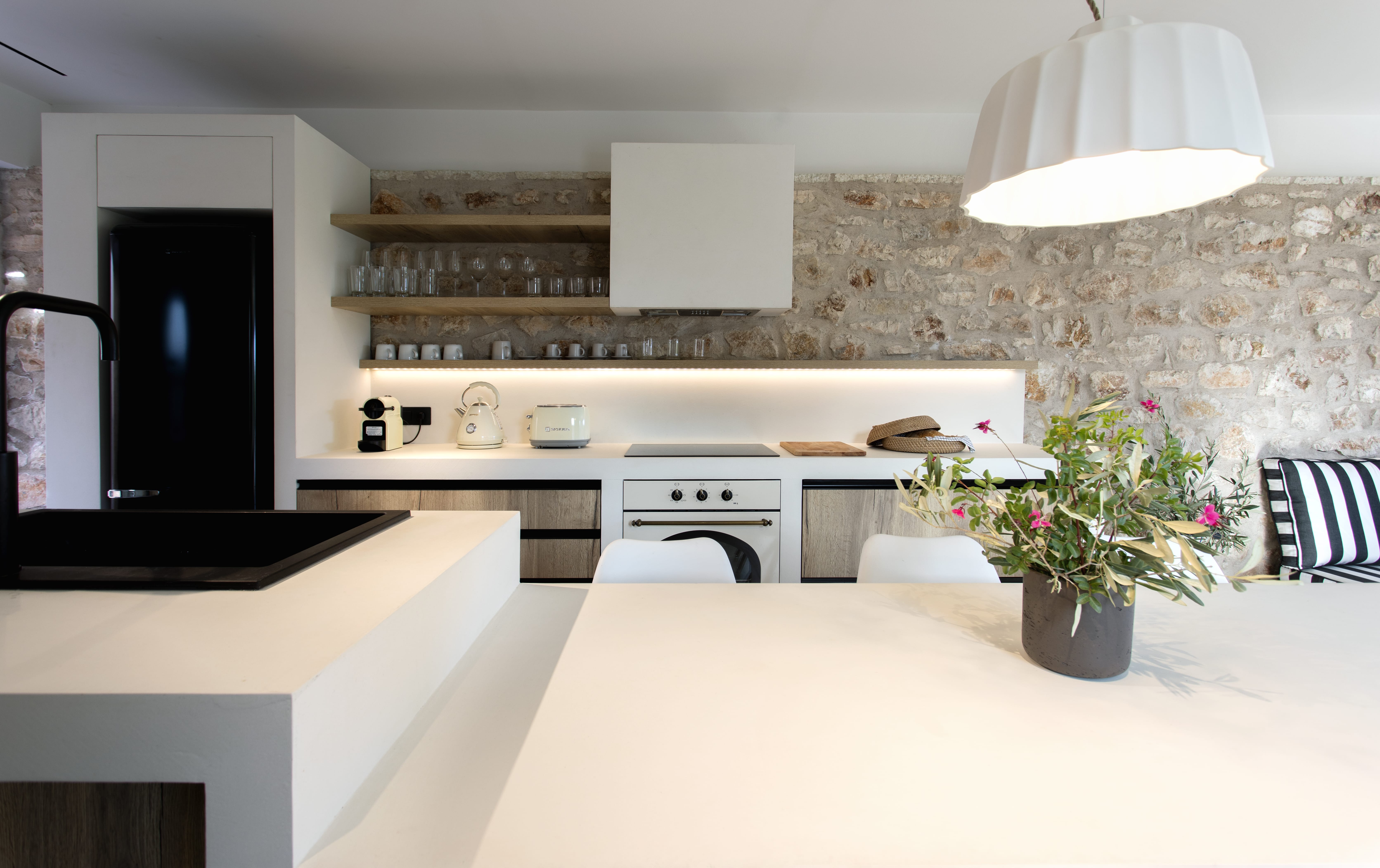 a kitchen with a table and a plant