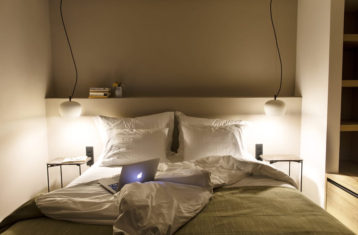a bed with a laptop on it