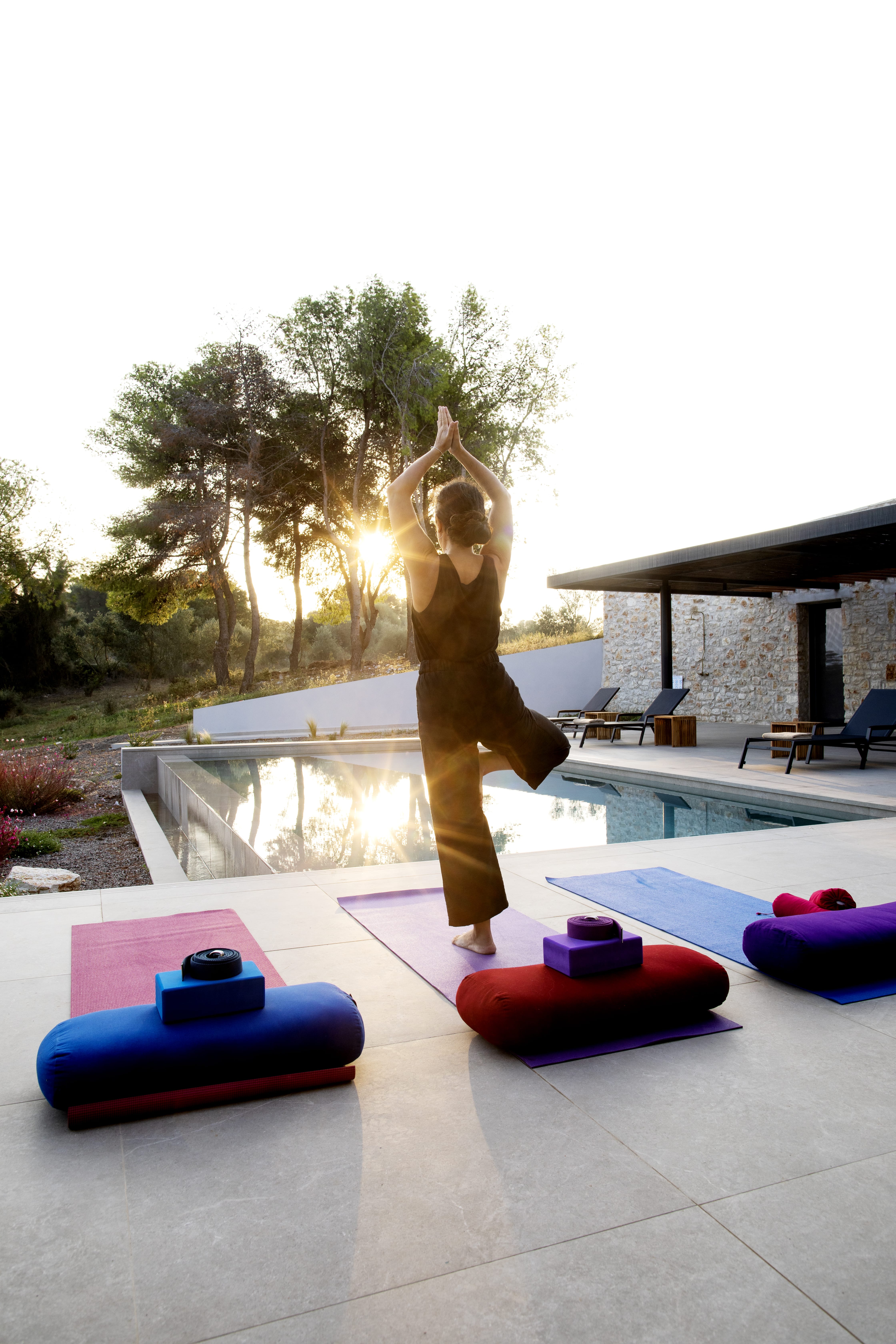 a statue of a person holding a ball and standing on a deck