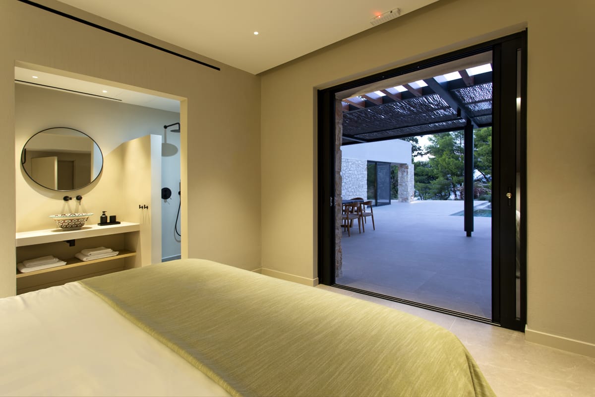 a bedroom with a large glass door