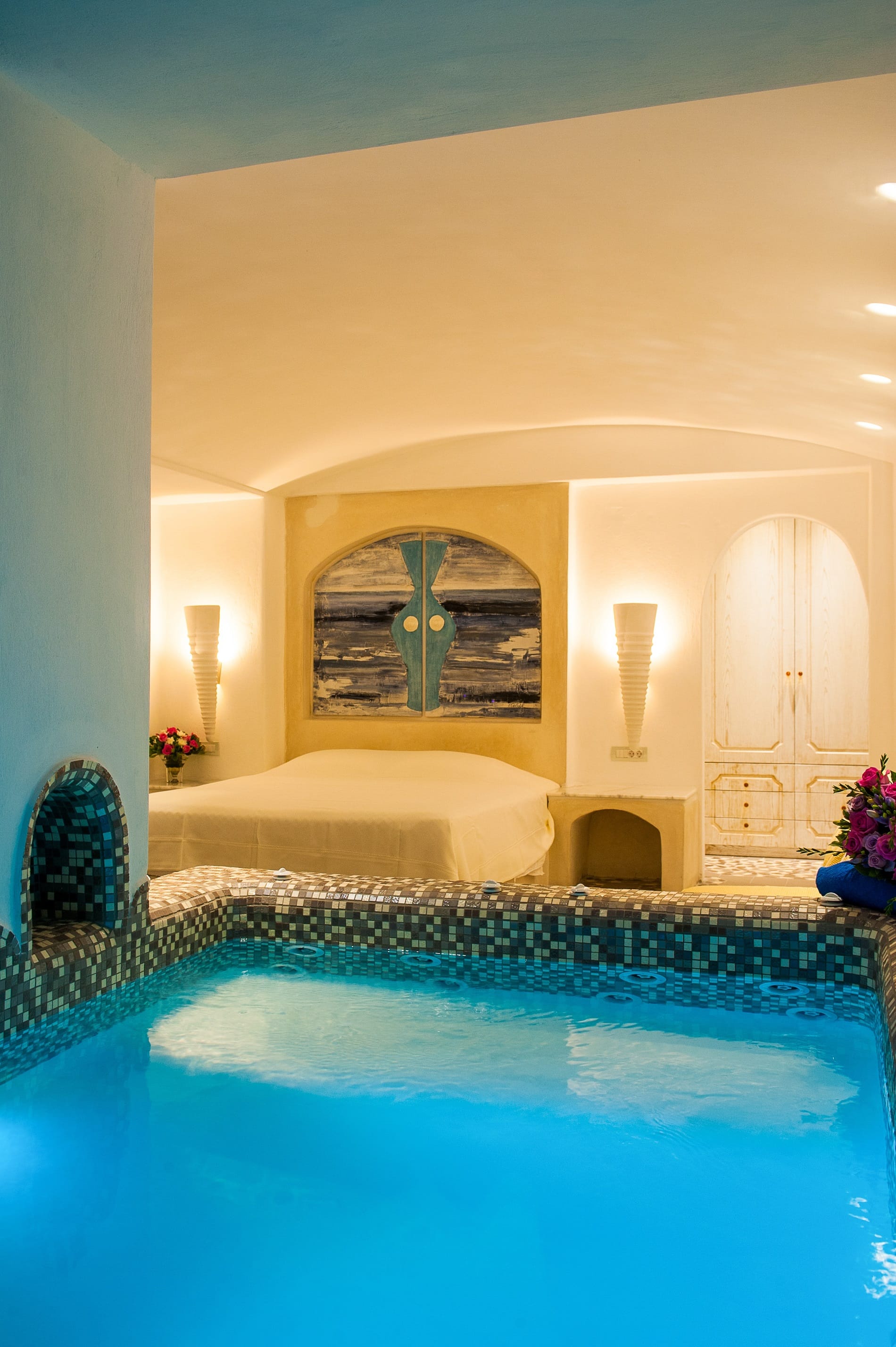 a large room with a large bed and a large mirror