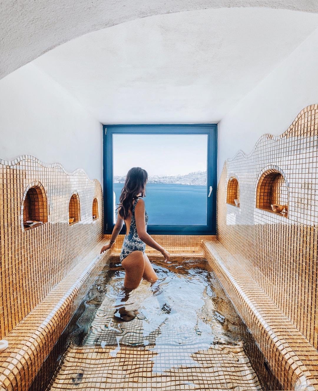 a person sitting on a stone walkway