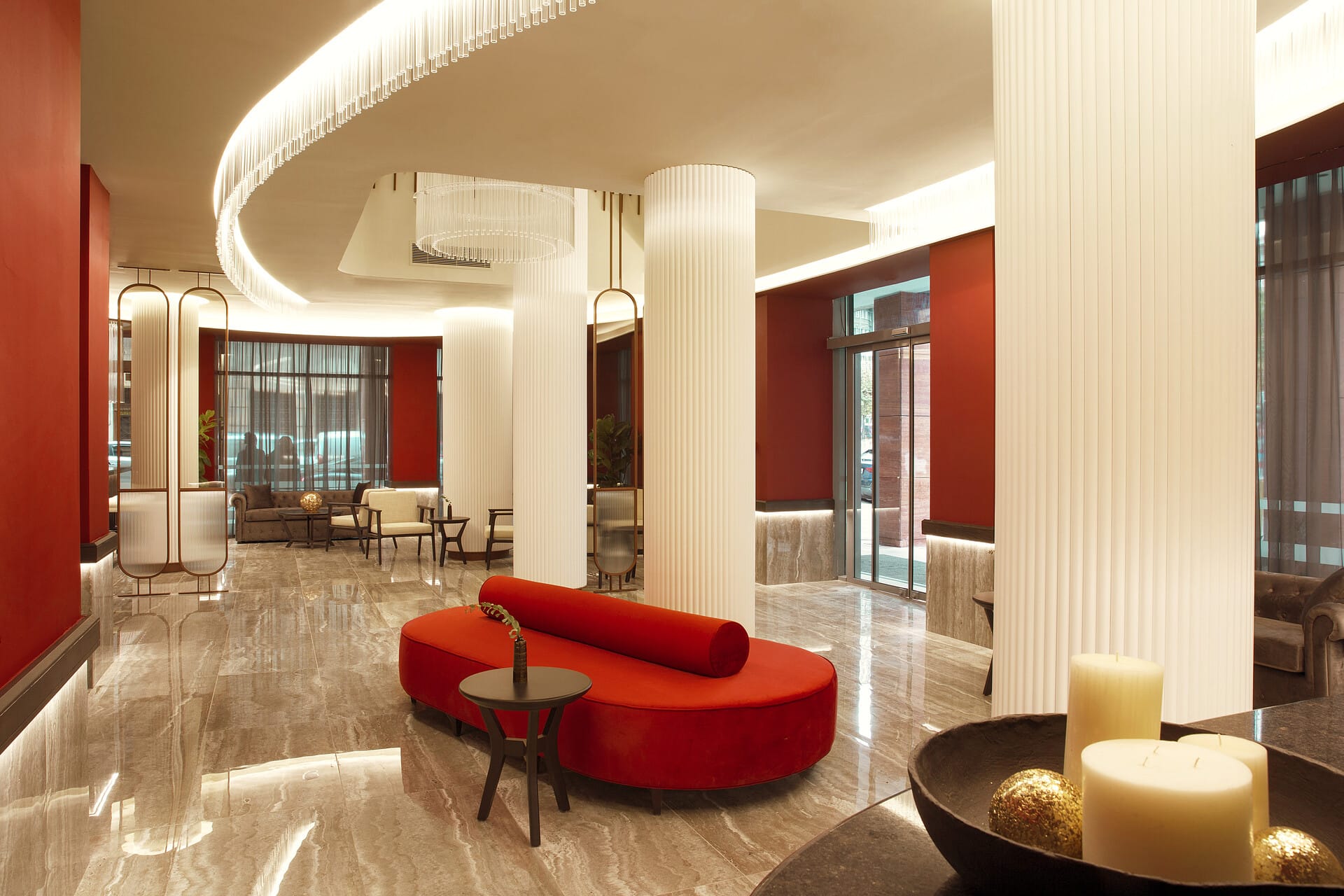 a room with red couches and a table