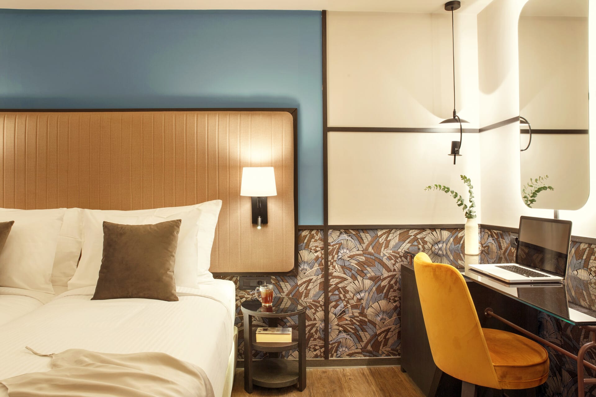 a bedroom with a bed desk and lamp