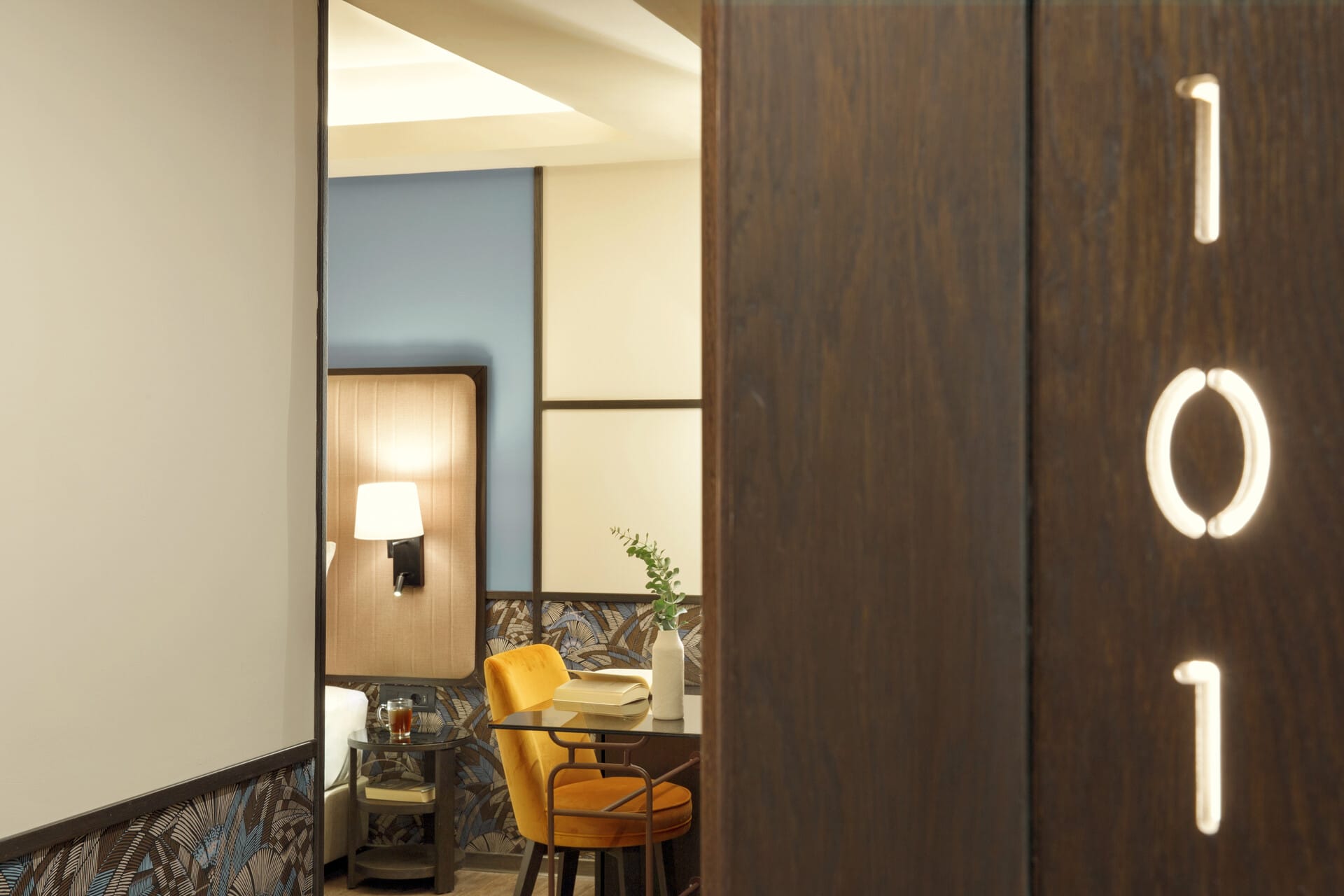 a room with a mirror and a chair