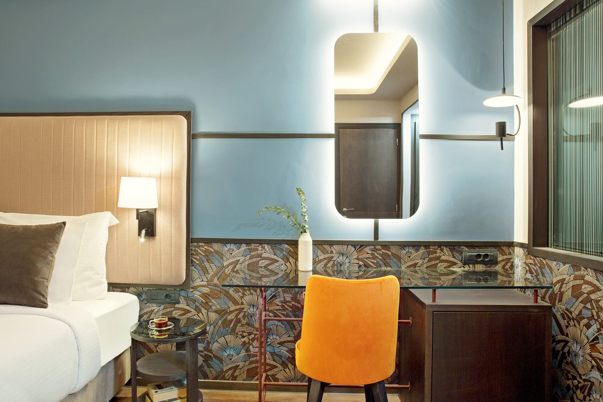 a bathroom with a mirror and a chair