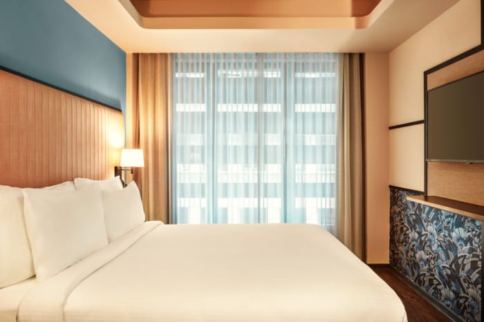 a bed with a white comforter