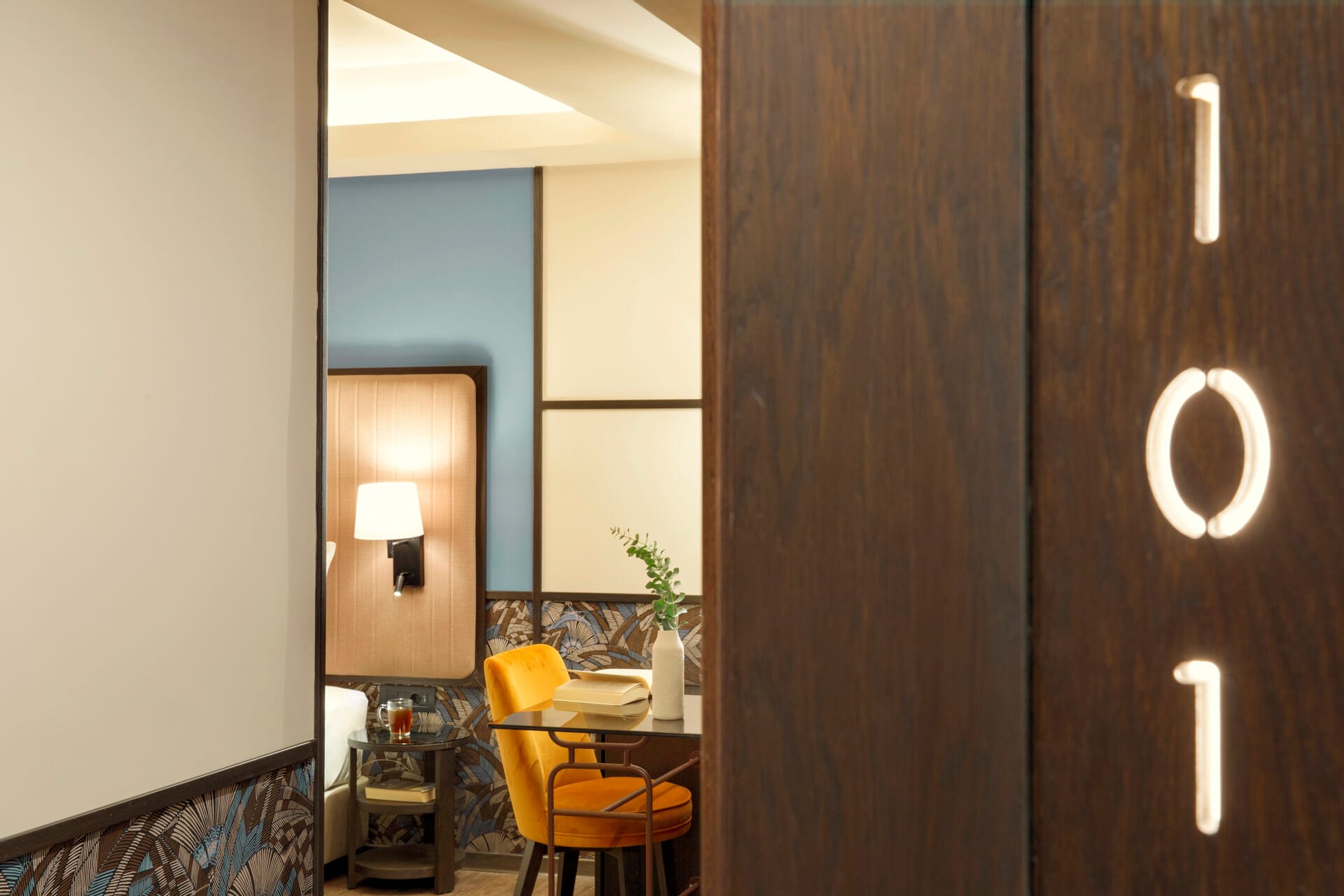 a room with a mirror and a chair