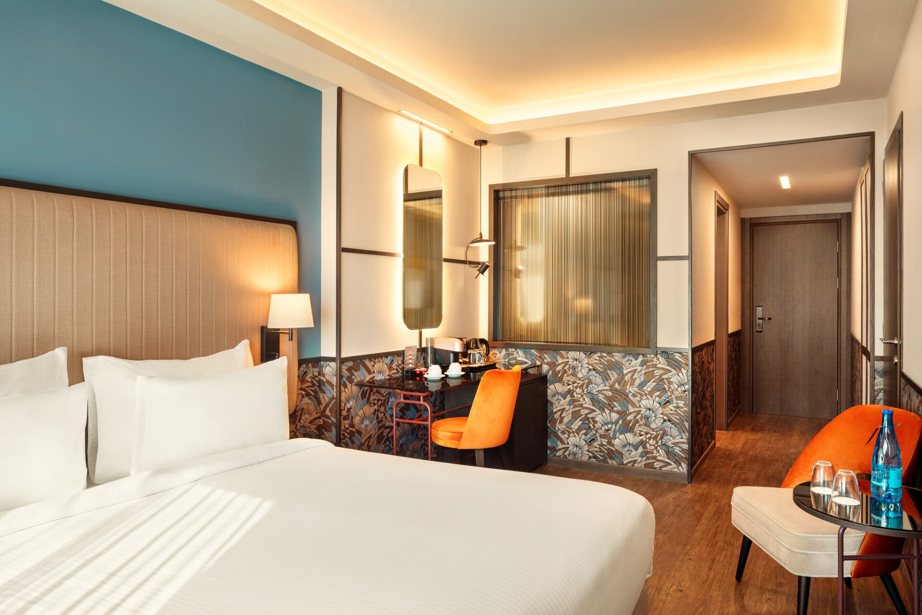 a hotel room with a bed and a chair