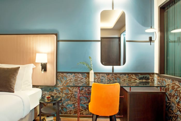 a bathroom with a mirror and a chair