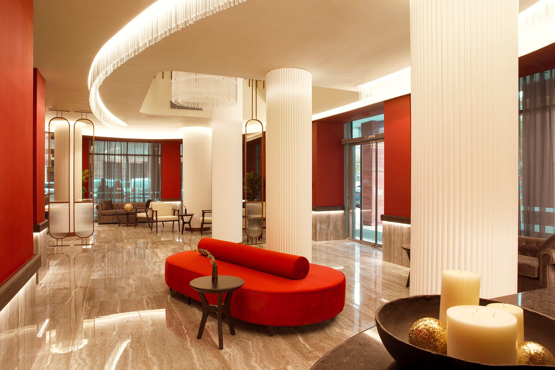 a room with red couches and a table