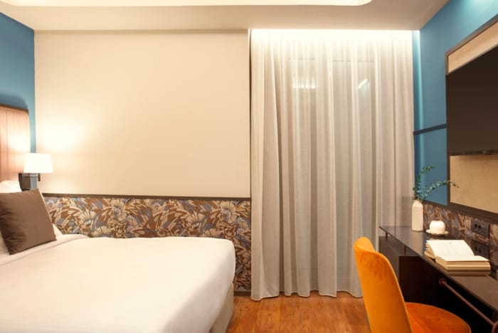 a room with a bed and a desk