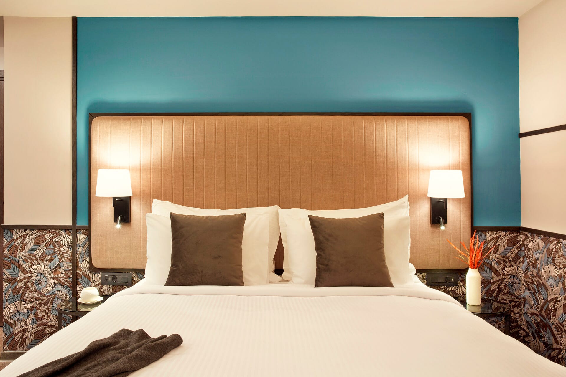 a bed with lamps on either side