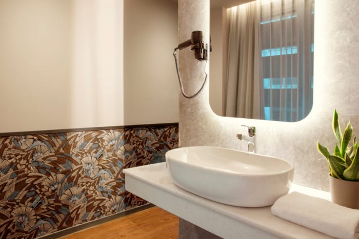 a bathroom with a sink and a plant