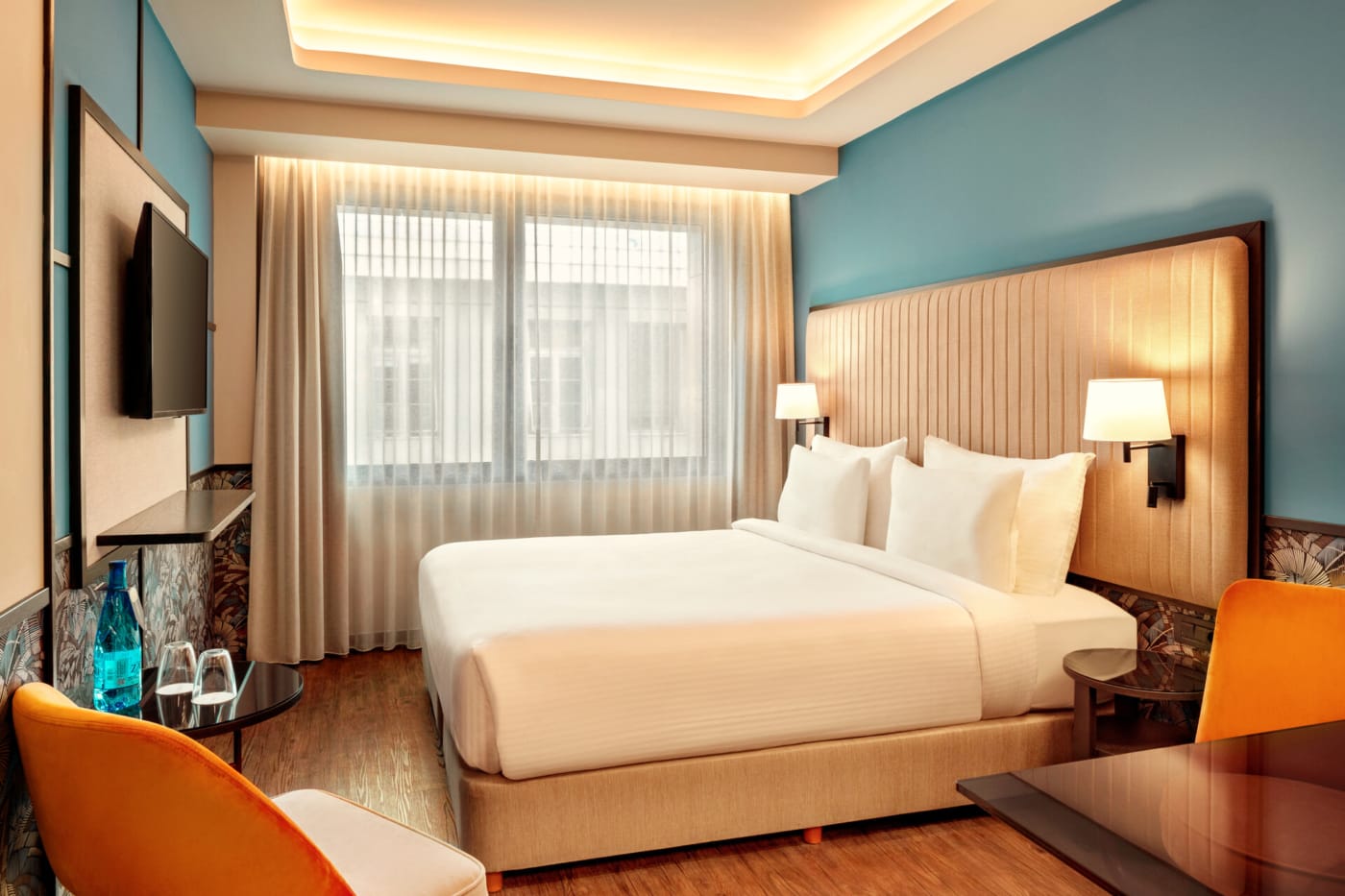 a hotel room with a bed and a tv