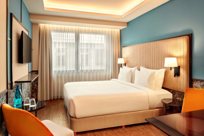 a hotel room with a bed and a tv
