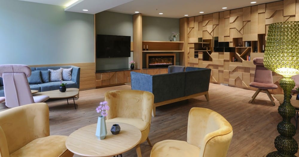 a room with a couch and chairs