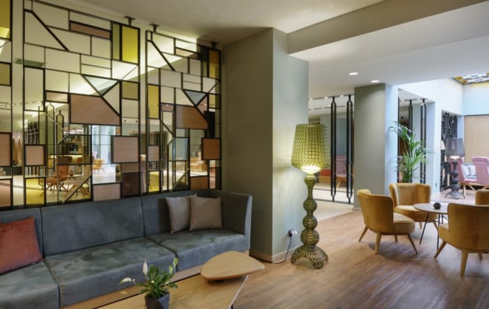 a living room with a couch and chairs