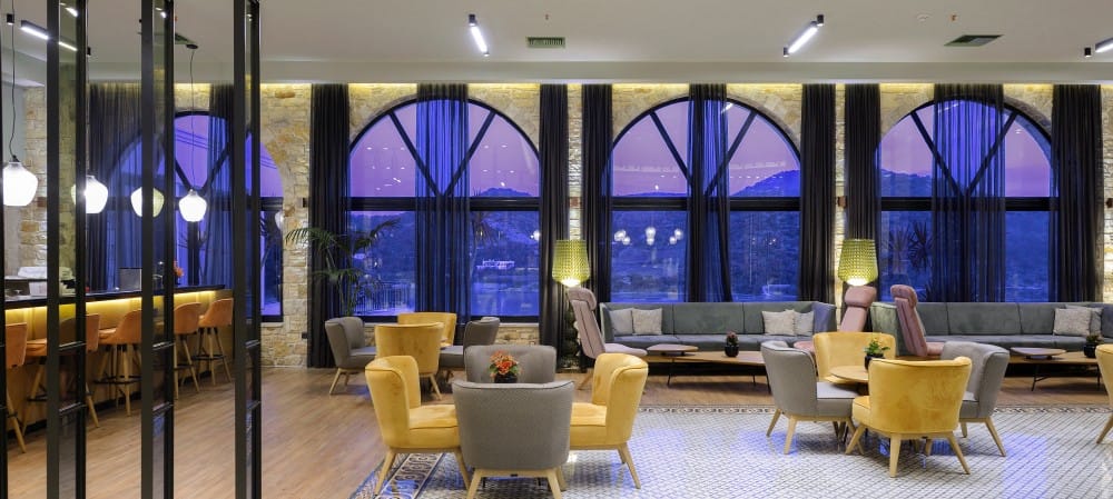 a room with a large window and chairs