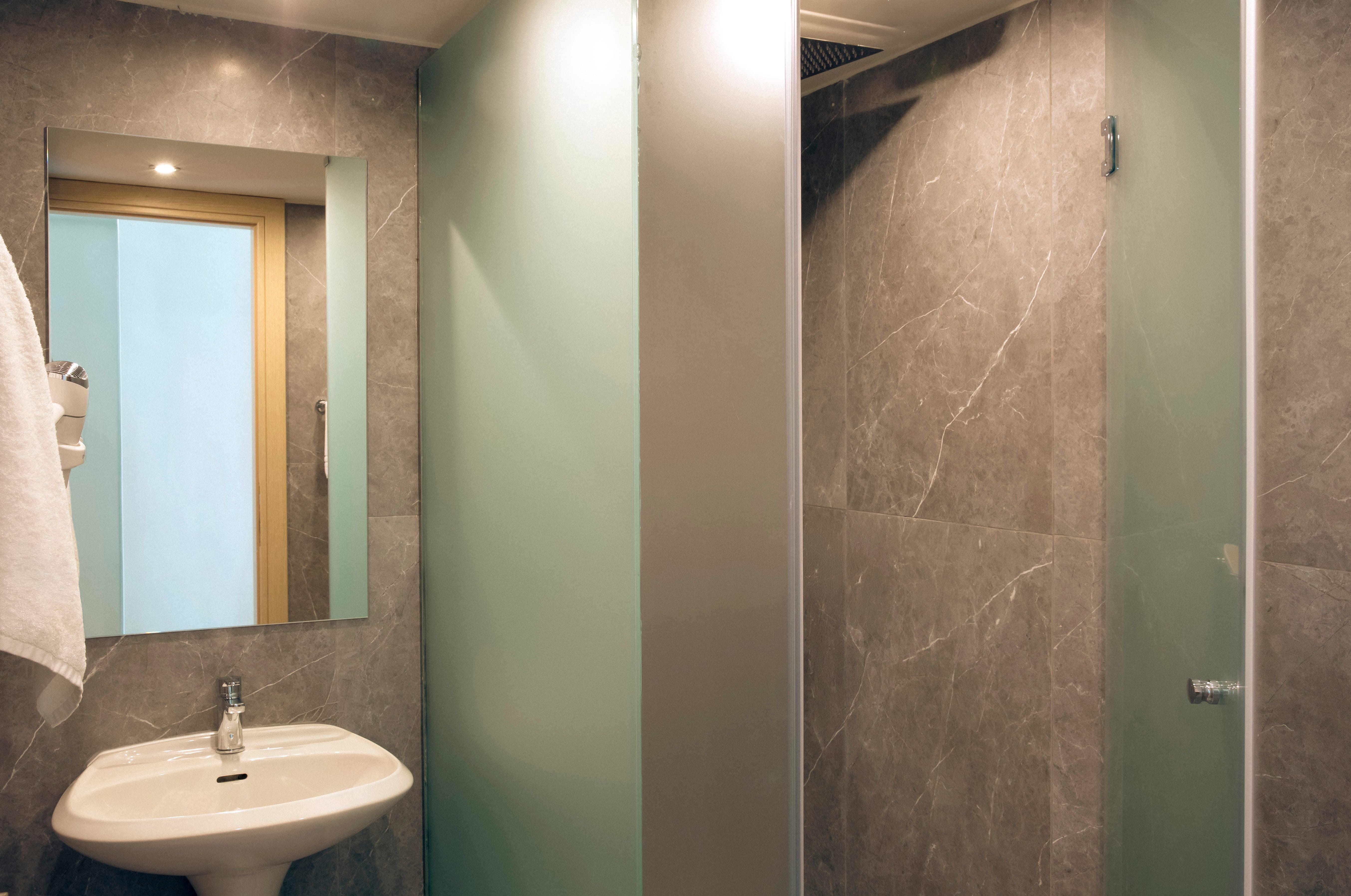 a bathroom with a mirror and a sink