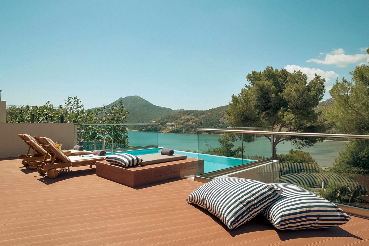 a deck with a pool and chairs