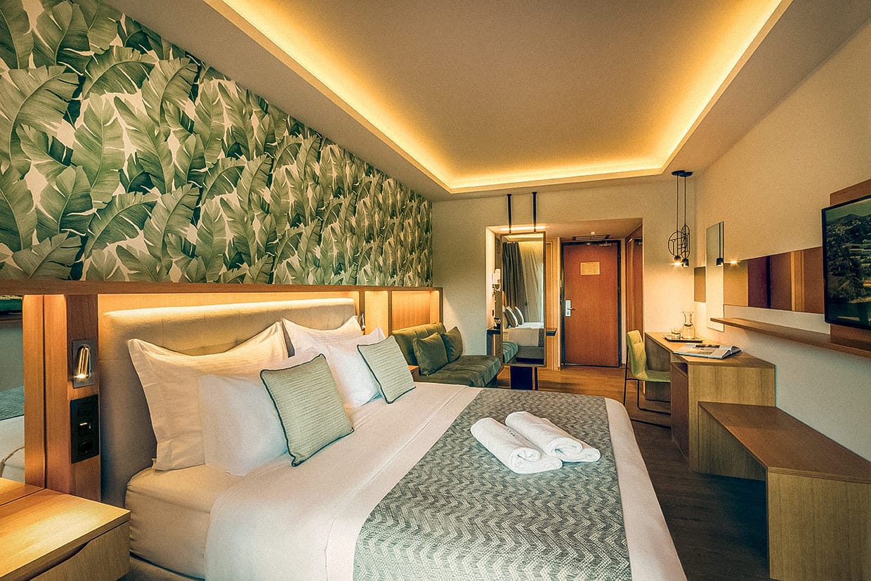 a hotel room with a bed and a desk