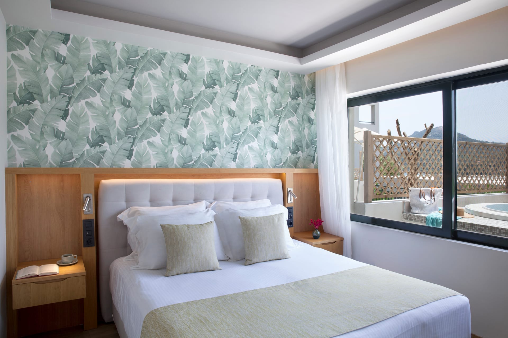 a bed with pillows and a window