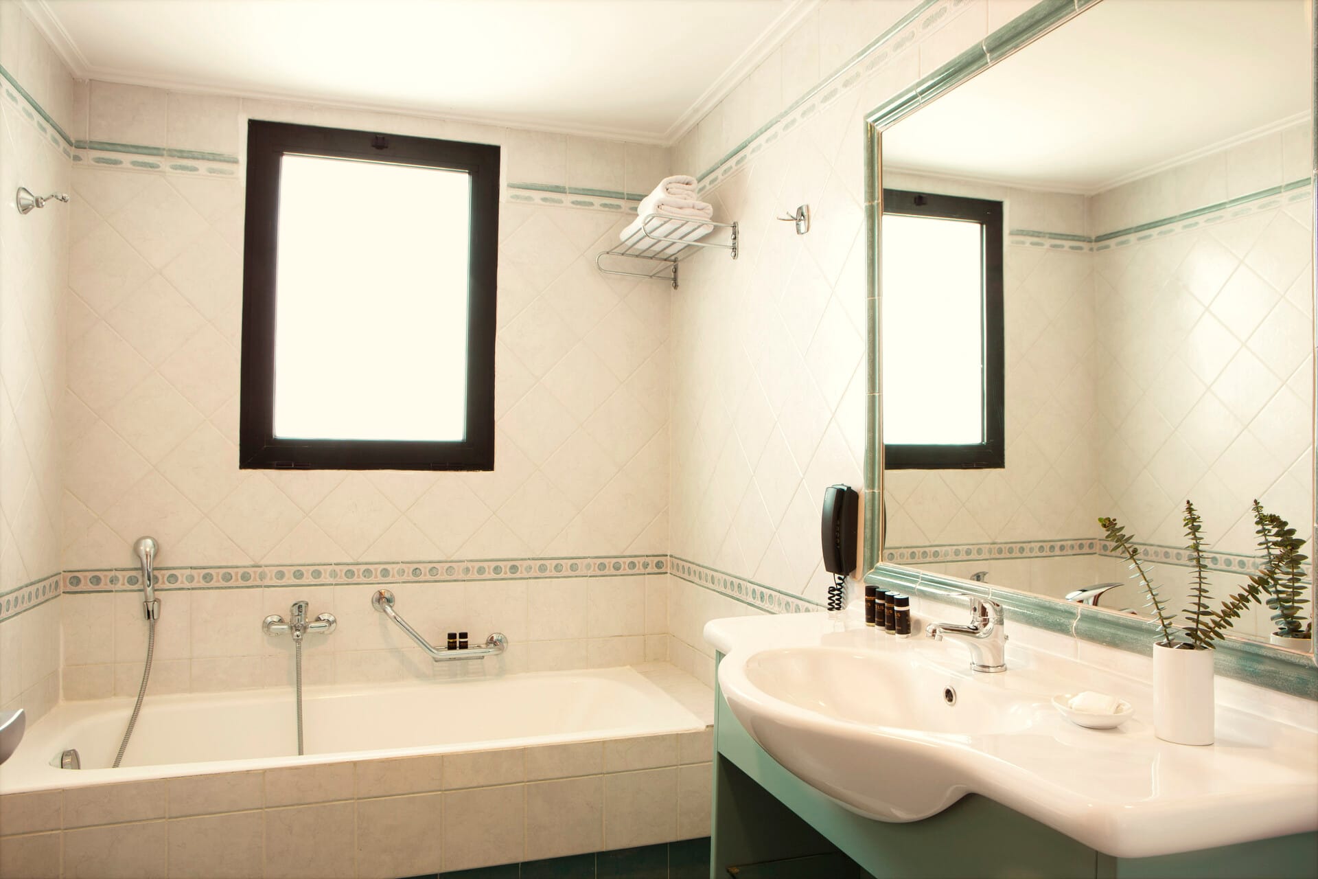 a bathroom with a tub sink and mirror