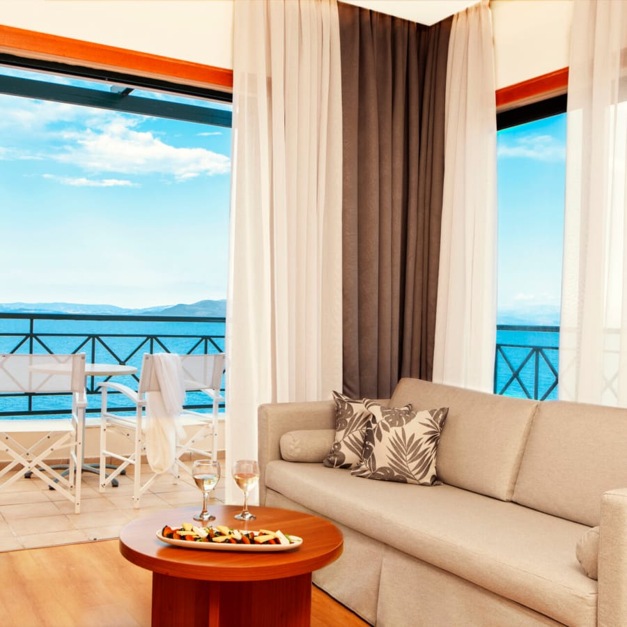 a living room with a view of the ocean