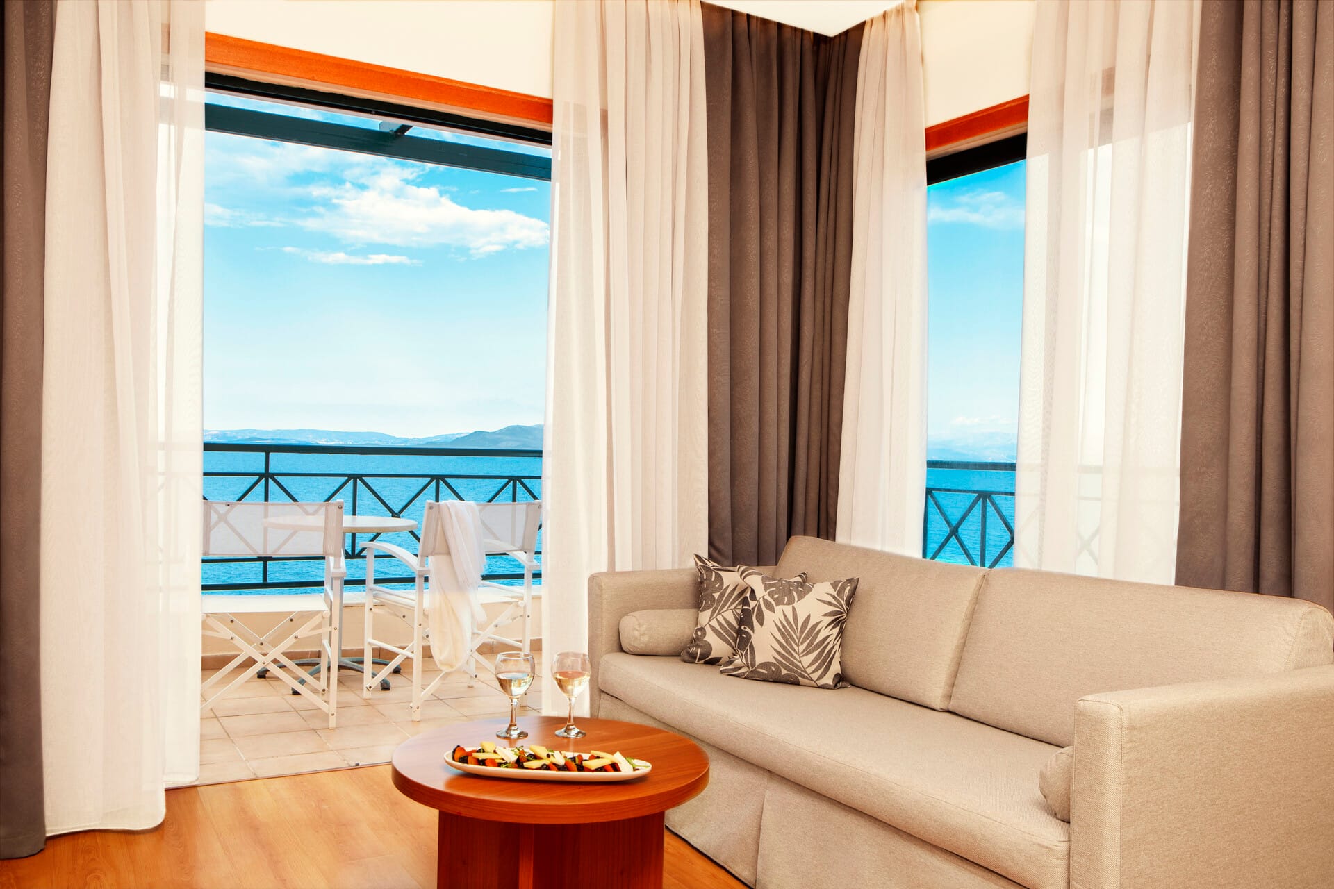 a living room with a view of the ocean