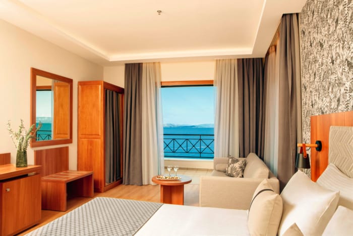 a bedroom with a view of the ocean