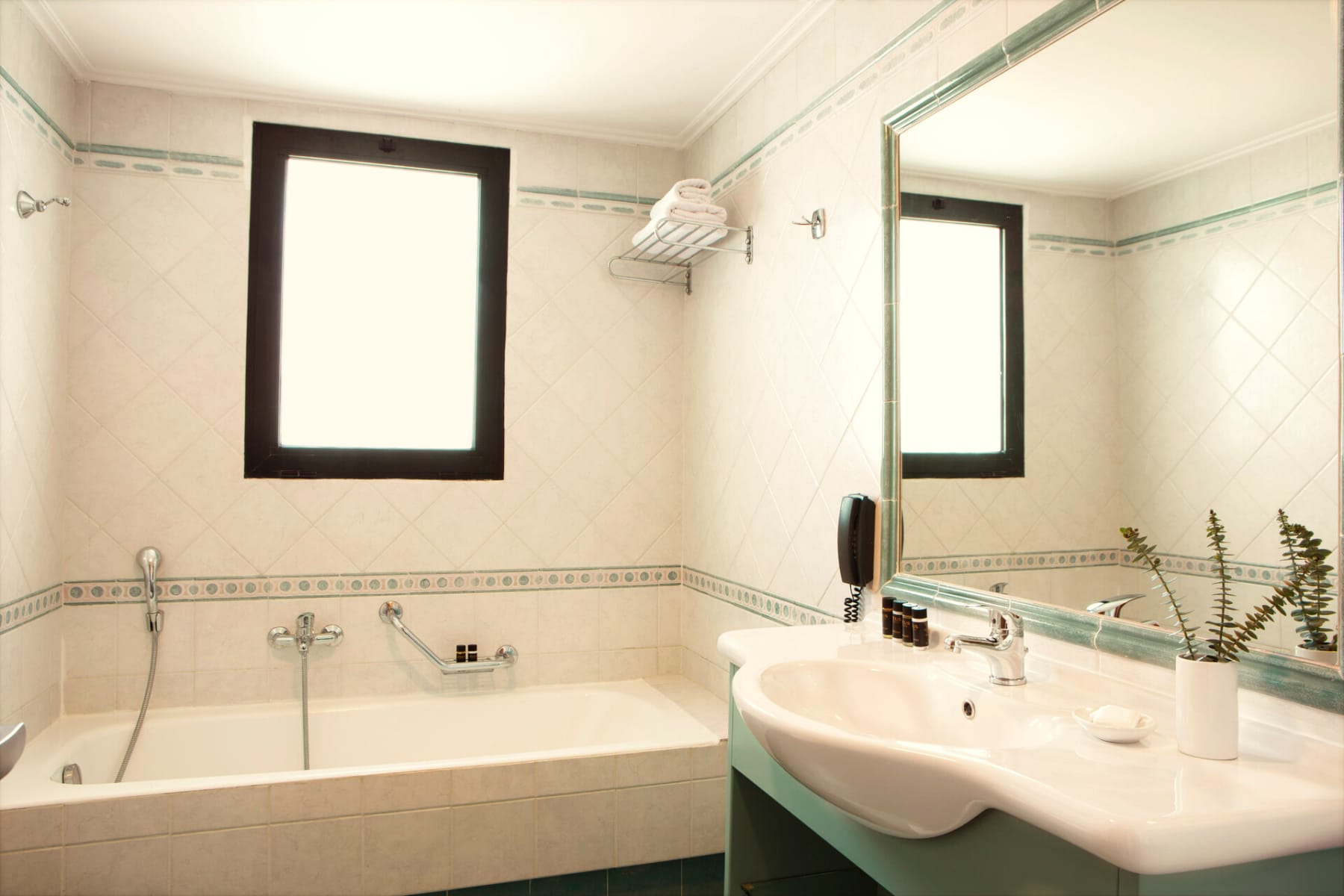 a bathroom with a tub sink and mirror