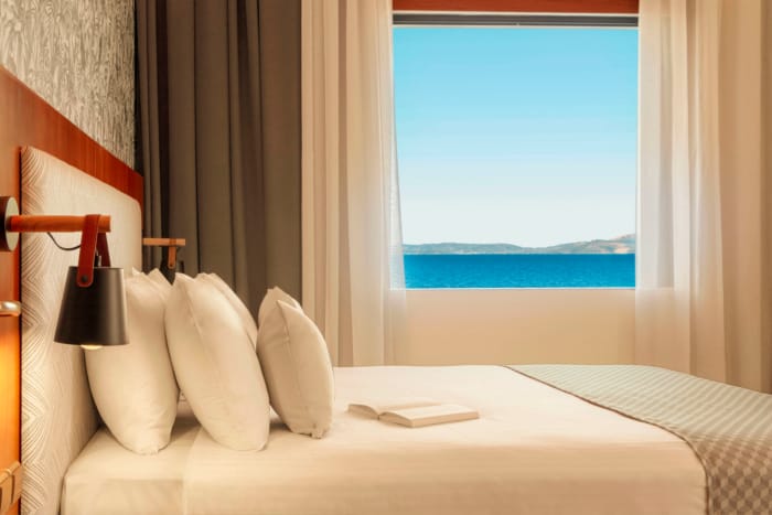 a bed with pillows and a lamp