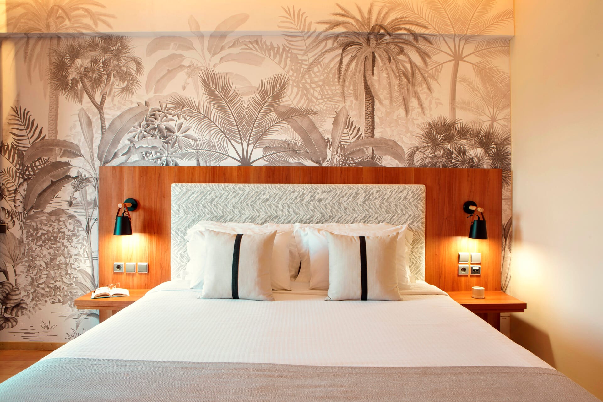 a bed with lamps on the side