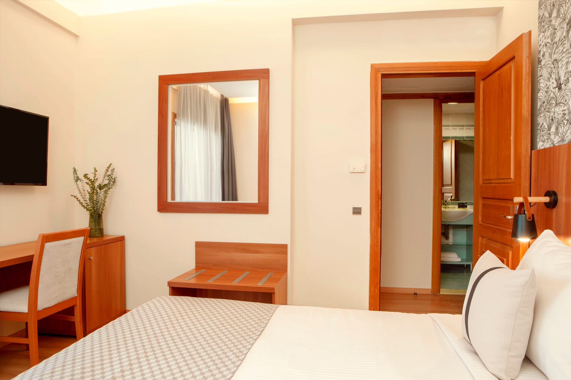 a bedroom with a bed and a mirror